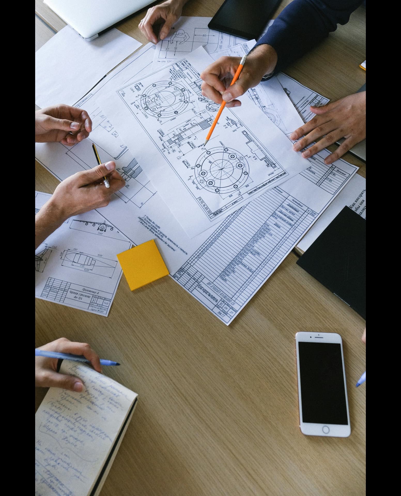 Procurement team reviewing QC engineer contracts and rate sheets at a Saudi project office